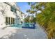 A luxurious pool and hot tub surrounded by lush landscaping create a private, relaxing backyard oasis at 3319 S Osprey Ave, Sarasota, FL 34239