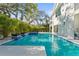 Beautiful backyard pool featuring a spa, outdoor kitchen, and lush tropical landscaping perfect for entertaining at 3319 S Osprey Ave, Sarasota, FL 34239