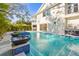 Stunning pool area with swim-up bar seating and a built-in outdoor grill at 3319 S Osprey Ave, Sarasota, FL 34239