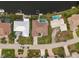 Aerial view of a beautiful home with a pool, lush landscaping, and waterfront access at 360 Capri Isles Ct, Punta Gorda, FL 33950