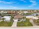 Aerial view of a waterfront home with lush landscaping, boat dock, and canal access at 360 Capri Isles Ct, Punta Gorda, FL 33950