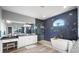 Modern bathroom with stone floors, walk-in shower, tub, and large vanity at 360 Capri Isles Ct, Punta Gorda, FL 33950
