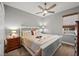 Cozy bedroom with a ceiling fan, neutral paint, and a large window that lets in plenty of natural light at 360 Capri Isles Ct, Punta Gorda, FL 33950