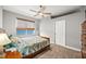 This bedroom includes a ceiling fan, neutral paint, and a large window that lets in plenty of natural light at 360 Capri Isles Ct, Punta Gorda, FL 33950