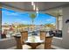 Dining area overlooking outdoor pool and waterfront view with clear, sun-filled skies, and comfortable seating at 360 Capri Isles Ct, Punta Gorda, FL 33950