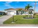 Charming home with manicured lawn, blue accent trim, and neat landscaping for a welcoming exterior at 360 Capri Isles Ct, Punta Gorda, FL 33950