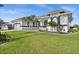 Attractive home with a manicured lawn, sleek black and white accents, and tidy landscaping for curb appeal at 360 Capri Isles Ct, Punta Gorda, FL 33950