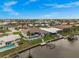 Well-manicured waterfront property featuring a private pool and dockside seating at 360 Capri Isles Ct, Punta Gorda, FL 33950