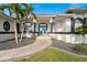 Bright, attractive home exterior with a well-maintained lawn, elegant entryway, and lush landscaping at 360 Capri Isles Ct, Punta Gorda, FL 33950