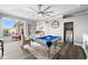Game room featuring a pool table, ceiling fan, and windows that offer beautiful water views and access to the pool area at 360 Capri Isles Ct, Punta Gorda, FL 33950