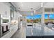 Modern kitchen featuring stainless steel appliances, a large island, and granite countertops with an open view of the backyard at 360 Capri Isles Ct, Punta Gorda, FL 33950