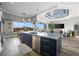 Modern kitchen island with elegant countertop, complemented by an open view of the living area at 360 Capri Isles Ct, Punta Gorda, FL 33950