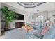 Comfortable living room with a large tv, area rug, large windows, and modern furniture at 360 Capri Isles Ct, Punta Gorda, FL 33950