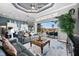 Open living space with comfortable couches, a seamless indoor-outdoor flow, and a modern kitchen at 360 Capri Isles Ct, Punta Gorda, FL 33950