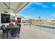 Inviting outdoor patio with comfortable seating overlooking a sparkling pool and waterfront view at 360 Capri Isles Ct, Punta Gorda, FL 33950