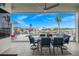 Covered patio overlooking the pool and waterfront, perfect for outdoor dining and entertaining with tropical landscaping at 360 Capri Isles Ct, Punta Gorda, FL 33950