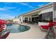 Inviting pool area with seating and lush landscaping, perfect for outdoor relaxation and entertaining guests at 360 Capri Isles Ct, Punta Gorda, FL 33950