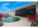 Inviting pool area with seating and lush landscaping, perfect for outdoor relaxation and entertaining guests at 360 Capri Isles Ct, Punta Gorda, FL 33950