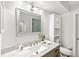 Bathroom with a large mirror, vanity, marble countertop and modern lighting at 3608 Spainwood Dr, Sarasota, FL 34232