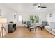 Cozy living area with wood floors, seating, and natural light creating an inviting atmosphere at 3608 Spainwood Dr, Sarasota, FL 34232