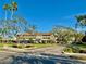 Well-maintained condo complex with lush landscaping and mature trees on a bright, sunny day at 3987 Maceachen Blvd # 132, Sarasota, FL 34233
