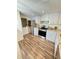 Bright kitchen featuring stainless steel appliances, granite countertops, and modern wood flooring at 3987 Maceachen Blvd # 132, Sarasota, FL 34233