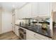 Bright kitchen with white cabinetry, stainless steel appliances, and a mirrored backsplash, perfect for cooking at 4468 White Egret Ln, Sarasota, FL 34238