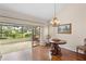 Dining area with hardwood floors, chandelier, and sliding glass doors to lanai at 4527 La Jolla Dr, Bradenton, FL 34210