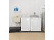 Functional laundry area with a washing machine, dryer, and utility sink at 4527 La Jolla Dr, Bradenton, FL 34210