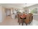 Dining area with tile flooring, wicker chairs, and adjacent to the kitchen at 4734 Independence Dr # 4734, Bradenton, FL 34210