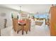 Open-concept dining room with wicker chairs and living room with water views at 4734 Independence Dr # 4734, Bradenton, FL 34210