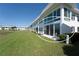 Condo exterior with large windows, sliding glass doors, lawn, and view of the water at 4734 Independence Dr # 4734, Bradenton, FL 34210