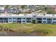 Condo exterior featuring a lawn, and sliding glass doors with water views at 4734 Independence Dr # 4734, Bradenton, FL 34210