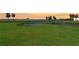 Expansive green golf course landscape with a pond, fountain, and scenic water views in the background at 4734 Independence Dr # 4734, Bradenton, FL 34210