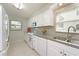 Well-lit kitchen features white appliances, stylish backsplash, ample storage and sink by the window at 4734 Independence Dr # 4734, Bradenton, FL 34210