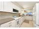 Bright open kitchen with white cabinets, updated appliances and breakfast bar overlooking the dining area at 4734 Independence Dr # 4734, Bradenton, FL 34210