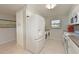 This modern kitchen is equipped with a stainless steel refrigerator and a washer and dryer at 4734 Independence Dr # 4734, Bradenton, FL 34210