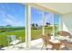 Enclosed lanai featuring tile floors and beautiful views of the water and lush green landscaping at 4734 Independence Dr # 4734, Bradenton, FL 34210