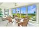 Lanai with tile floor, wicker seating, and bright windows with water and golf course views at 4734 Independence Dr # 4734, Bradenton, FL 34210