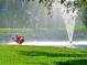 Scenic community pond featuring a fountain and birds along the verdant green lawn at 4734 Independence Dr # 4734, Bradenton, FL 34210
