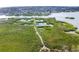 Expansive aerial view of a property highlighting its natural surroundings with lush greenery and winding waterways at 4920 Kestral Park Cir # 11, Sarasota, FL 34231