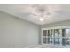 Bright bedroom features a ceiling fan and sliding glass door at 4920 Kestral Park Cir # 11, Sarasota, FL 34231