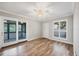 Bedroom featuring wood floors, a ceiling fan, and sliding door access to screened-in patio at 4920 Kestral Park Cir # 11, Sarasota, FL 34231