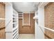 Walk-in closet featuring built-in shelving and ample storage space at 4920 Kestral Park Cir # 11, Sarasota, FL 34231