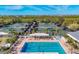 An aerial view shows the community pool, spa, and tennis courts for an active lifestyle at 4920 Kestral Park Cir # 11, Sarasota, FL 34231