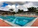 Enjoy the spacious community pool on a sunny day with ample space for relaxation at 4920 Kestral Park Cir # 11, Sarasota, FL 34231
