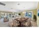 Elegant dining area adjacent to the living room, featuring a table set for six and natural lighting at 4920 Kestral Park Cir # 11, Sarasota, FL 34231