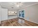 Dining room featuring wood floors and sliding door access to the screened-in patio and kitchen access at 4920 Kestral Park Cir # 11, Sarasota, FL 34231
