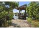 Wooden gazebo on the water's edge offers scenic views and a relaxing atmosphere at 4920 Kestral Park Cir # 11, Sarasota, FL 34231