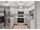 Well-lit kitchen features stainless steel appliances, white cabinets, and granite countertops at 4920 Kestral Park Cir # 11, Sarasota, FL 34231